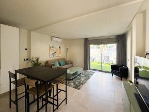 a living room with a table and a couch at ON City Apartments in Matalascañas