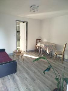 a living room with a table and chairs at Studio in Blois