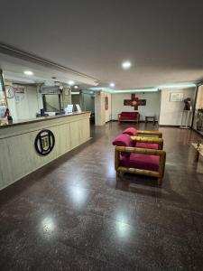 a waiting room with couches and tables in a building at Hotel Harmony in Caracas