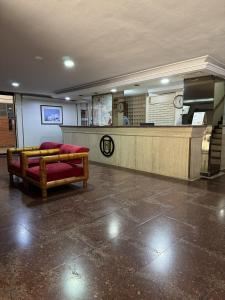 a waiting room with a bench in a lobby at Hotel Harmony in Caracas