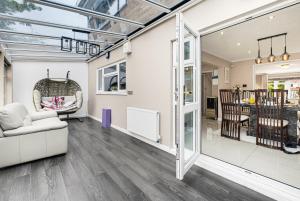 an open living room with a couch and a chair at Spacious 4BR with Parking for Groups & Contractors in Solihull