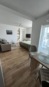 a living room with a bed and a couch at DIV Apartman in Vrnjci