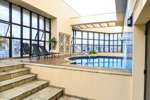 a swimming pool in the middle of a building at Ninety Hotel in São Paulo