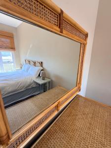 a large mirror in a bedroom with a bed at Praia Longa 4 in Rand Rifles