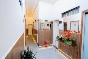 a hallway of an office building with flowers in baskets at AIRPORT HOTEL GRU LTDa in Guarulhos