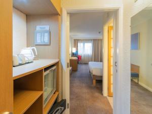 a hotel room with a kitchen and a bedroom at Novotel Southampton in Southampton