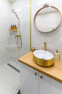 a bathroom with a wooden sink and a mirror at Kaposvár Deluxe Apartman in Kaposvár