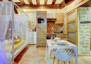 a kitchen and living room with a table and chairs at Bed & Spa - La Parenthese in Dijon