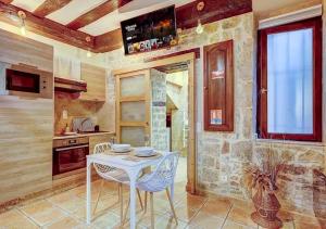 a kitchen with a white table and chairs at Bed & Spa - La Parenthese in Dijon