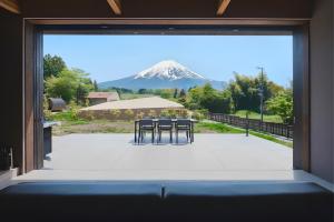 a view of a mountain through a window at THE THIRD PLACE Mt Fuji in Fujikawaguchiko