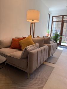 a couch with pillows on it in a living room at Hotel LUMIè Pescasseroli in Pescasseroli