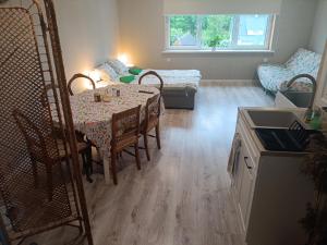 a room with a table and chairs and a living room at Näkmani 3 in Kõrgessaare