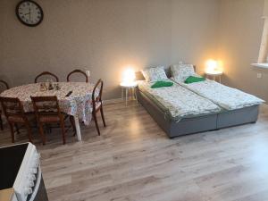 a bedroom with two beds and a table and chairs at Näkmani 3 in Kõrgessaare