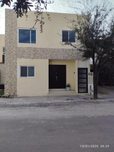 a white house with a black garage at casa confortabla y relajante con alberca y laguna in Monterrey