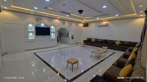 a large living room with a couch and a table at شاليه سما in Taif