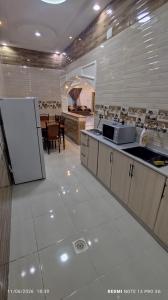 a kitchen with a refrigerator and a counter top at شاليه سما in Taif
