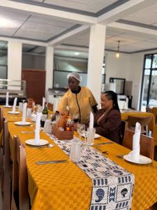 a man and a woman sitting at a table at Njiro Luxury in Arusha