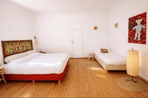 a bedroom with a bed and a couch in it at villa marguerite in Lunas