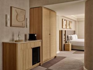 a hotel room with a fireplace and a bed at The Brighton Hotel Sydney - Mgallery Collection in Sydney