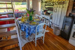a dining room with a table and chairs in a kitchen at Ala Sarise saunamaja in Sarise +24 photos