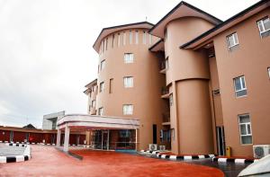 a view of a building with a courtyard at Swisse International Rancho Valeria Hotel & Suites in Warri