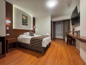 a hotel room with a bed and a desk at Hotel Yanahuara Suite in Arequipa