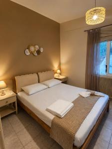 a bedroom with a large bed with two white pillows at Camvas Apartments in Panormos Kalymnos