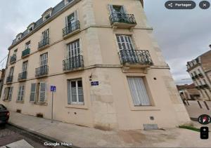 a large building with balconies on the side of it at Sous mon toit - Sauna & jacuzzi in Dijon