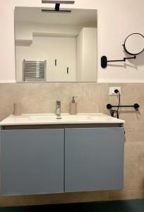a bathroom with a white sink and a mirror at Caraceni Apartaments 1 in Castel di Sangro