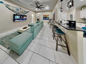 a living room with a couch and a kitchen at Ferrymans Landing in Aransas Pass