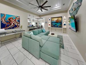 a living room with a blue couch and a television at Ferrymans Landing in Aransas Pass