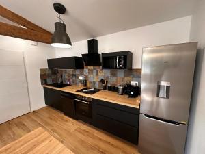 a kitchen with a stainless steel refrigerator at BlakRiverHouse - Sèvre Niortaise in Niort