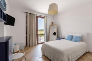a white bedroom with a bed and a window at Villa Cielo in Paceco +74 photos