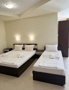 two beds sitting next to each other in a room at Апартаменти Спас 2 in Sinemorets +13 photos