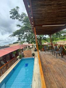 a resort with a swimming pool and a wooden deck at Cabañas Sol y Mar in San Antero