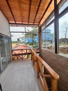 a porch with a wooden bench and windows at Cabañas Sol y Mar in San Antero