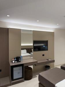 a hotel room with a large mirror and a bed at DriArt Center in Tirana