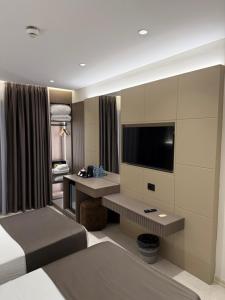 a hotel room with a bed and a television at DriArt Center in Tirana +50 photos