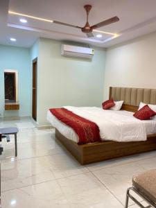 a bedroom with a bed and a ceiling fan at Hotel PR Royal in Bhīmavaram