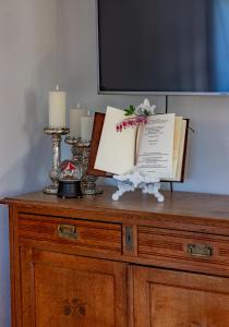 a wooden dresser with a tv on top of it at Ala Sarise saunamaja in Sarise