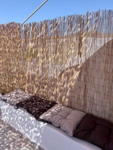 a dog bed sitting in front of a fence at Kanal Vstay #1 in Kithnos +2 photos