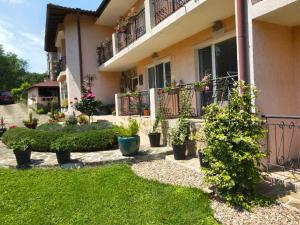 a house with plants on the side of it at Motivi Hotel in Saints Constantine and Helena