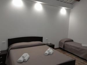 a bedroom with a bed with two slippers on it at Case Quattro Venti in Chiesa Nuova