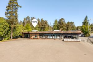 a large building with a sign on the front of it at Jääskän Loma Hostelli Antin Tupa in Härmä