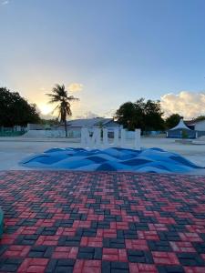 a brick road with the sun setting in the background at EcoWave Retreat- Muli in Muli