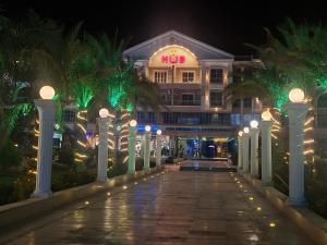 a hotel at night with palm trees and lights at Hurghada HuB in Hurghada +2 photos