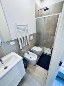 a bathroom with a sink and a toilet and a shower at Aden b&b in Casa Calari