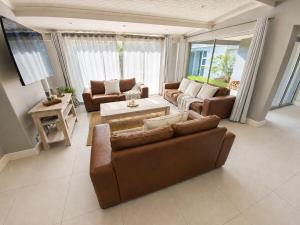 a living room with two couches and a tv at Pet-Friendly, 3-Bed, 2-Bath in Knysna Central in Knysna