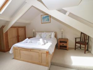 a bedroom with a large bed in a attic at Kipper Lodge in Dartmouth
