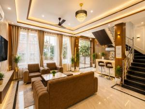a living room with a couch and a table at Stay By Shree Dharan Inn Near Shree Ram Mandir Ayodhya in Ayodhya